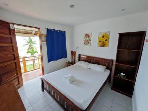 a bedroom with a bed and a window at Room-Cola Inn in Siquijor