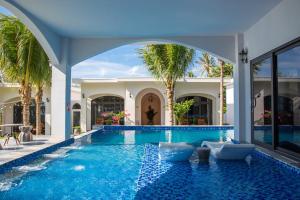 a swimming pool in the middle of a house at La'mer Villa Mũi Né in Phan Thiet