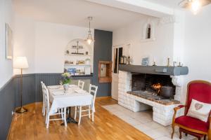 a living room with a table and a fireplace at LES PRIMEVERES in Saint-Jean-Saint-Nicolas