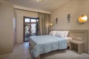 a bedroom with a bed and a balcony at Aelia Sivota in Syvota