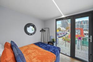 a bedroom with a bed and a balcony at Unique Water Lodge in London - Sleeps 6 in London