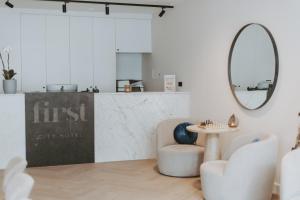 a living room with a table and a mirror at Boutique Hotel First City in The Hague