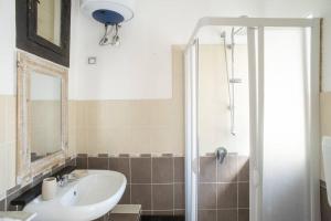 a bathroom with a sink and a shower at Al Khalisa Bright and cozy apt at Magione in Palermo