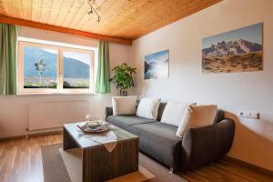 a living room with a couch and a table at Ferienwohnung am Gant in Bartholomäberg