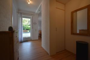 a room with a hallway with a mirror and a door at The Green Hills in Schmallenberg