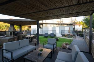 an outdoor patio with couches and chairs and a table at Villa Kriton Smart home in Máyiras