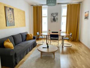 a living room with a couch and a table at 100 m2 Apartment - Free Parking- 15 min to Center in Vienna