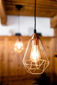 a glass light fixture hanging from a ceiling at heimatbude. 