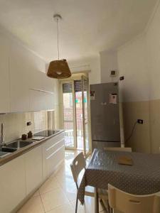 a kitchen with a table and a dining room at La Perla di Vanchiglia (500 meters from the Mole) in Turin +3 photos