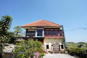 a house with a sign in front of it at OYO 927 Carina Hotel in Mojokerto