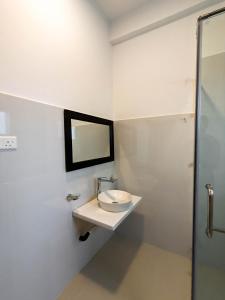 a bathroom with a sink and a mirror at The Aurelia in Gampola