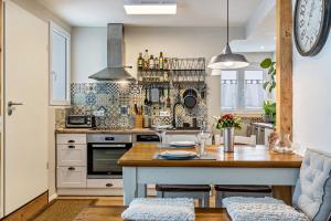 a kitchen with a large island with a wooden table at La 12 in Bad Urach