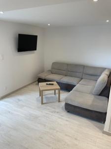a living room with a couch and a coffee table at Joli logement au pied des Alpilles in Eyguières +1 photo
