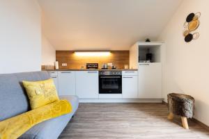 a living room with a couch and a kitchen at Monis Appartementhaus in Unterlamm