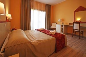 a hotel room with a bed and a desk at Ta 2 Pefka - Petros Italos in Neos Marmaras