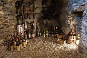 a bunch of bottles of wine sitting in a cave at Ca' Barroni - Vineyard Escape in Sondrio