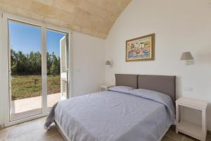 Postel nebo postele na pokoji v ubytování Villa Eneide by Perle di Puglia
