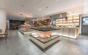 a large kitchen with several counters and tables at Garden View Court Suites Ho Chi Minh City in Ho Chi Minh City