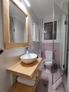 a bathroom with a bowl sink and a toilet at Verde Villas in Skala Potamias