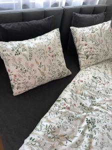 a couch with two pillows and a blanket at Apartament Przytulny 2, self check-in, blisko lotniska in Trzebownisko