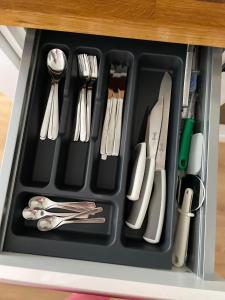 a tray filled with utensils in a drawer at Apartament Przytulny 2, self check-in, blisko lotniska in Trzebownisko