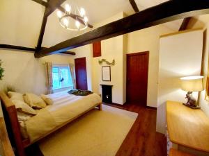 a bedroom with a large bed in a room at Yewtree Cottage in Strensall