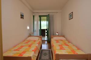 a room with two beds in a room at Apartments Margita in Rabac