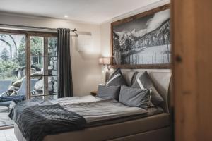 a bedroom with a bed with a picture on the wall at Chalet Ruhpolding Bayern in Ruhpolding