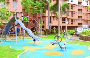 a playground in a park with a slide and slidesktop at Near Manila Airport, COZY 1 Bedroom Condo, Full Kitchen, Swimming Pool, WIFI, 10K in Manila