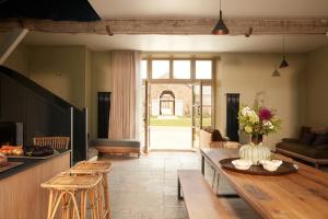 a living room with a table and a couch at DOMAINE LE MEZO in Ploeren