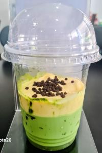 a drink in a plastic container with chocolate chips on it at Hamse Love Tour in Ấp Thiẹn Ái