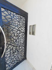 a black door with a metal screen next to a wall at Hurghada Pearl in Hurghada