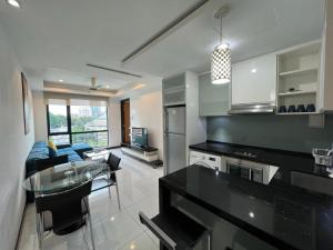 a kitchen and living room with a couch and a table at BBHomes at Casa Residency KL in Kuala Lumpur