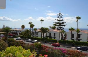 a view of a street with buildings and palm trees at Ocean blue 405 in San Bartolomé