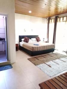 a bedroom with a bed in a room at Sandy Beach Resort By Casa Loma in Pantai Cenang