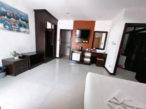 a large living room with a white tile floor at Abby's House Hotel in Patong Beach
