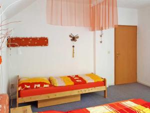 a bedroom with a bed and a cross on the wall at Ferienwohnung Seeluster Bucht in Plötzenhöhe