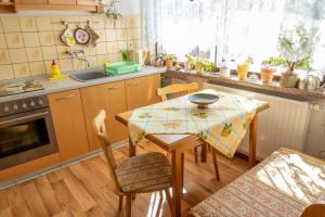 a kitchen with a table with a table cloth on it at Ferienwohnung an der Drei-Kaiser-Eiche in Freest