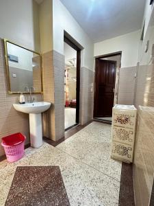 a bathroom with a sink and a mirror at Yahya Apartments in Ngambo