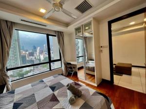 a bedroom with a bed and a large window at BBHomes at Casa Residency KL in Kuala Lumpur