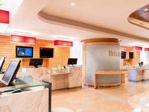 a lobby of a ups store with a desk at Ibis Hong Kong Central & Sheung Wan in Hong Kong