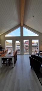 a large dining room with a table and chairs at Lofoten Rorbu - Odin bua in Stamsund