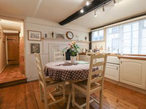 a kitchen with a table with chairs and a table and a table and chairsktop at Flushing House in Rye