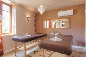 a barber shop with two stools and a mirror at L' Oriental Suite de Luxe in Serrières