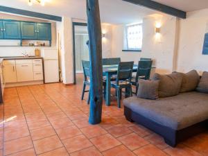 a living room with a couch and a table at Ferienhaus mit maritimer Einrichtung in Kröslin