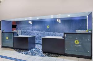 a lobby with two reception desks in a building at La Quinta by Wyndham Bowling Green in Bowling Green