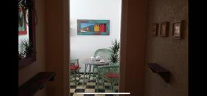 a room with a table and a chair and a painting at Cosy Art flats in central Budapest in Budapest
