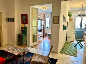 a living room with chairs and a table in it at Cosy Art flats in central Budapest in Budapest