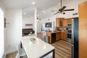 a kitchen with a white table and a ceiling fan at Relaxation Villa in Royal Palm Beach