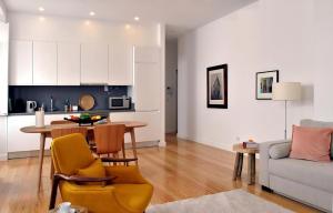 a kitchen and living room with a table and a couch at Alfama Prime Apartments by Homing in Lisbon